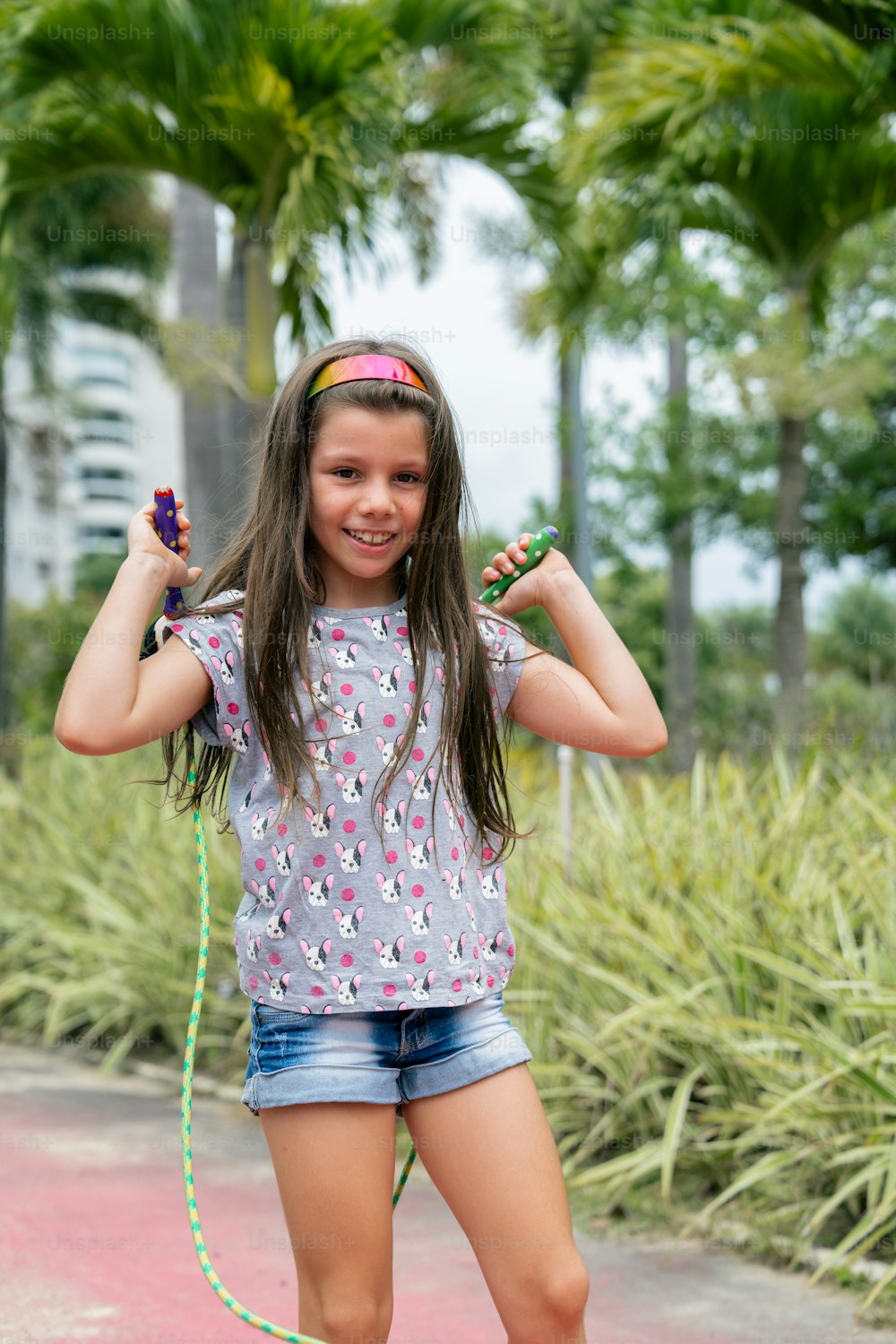 a young girl riding a skateboard on a sidewalk