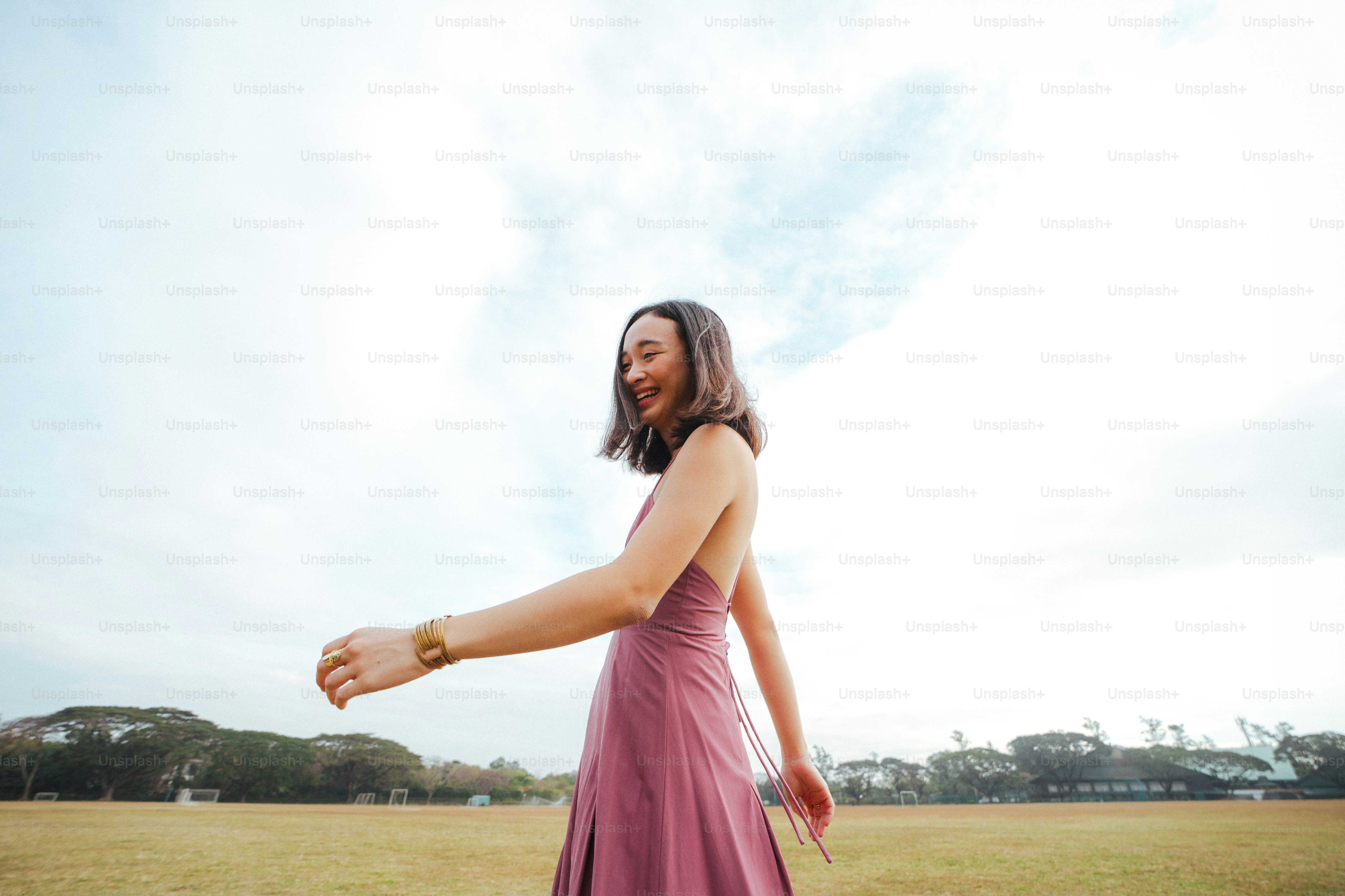 a woman in a pink dress holding a frisbee