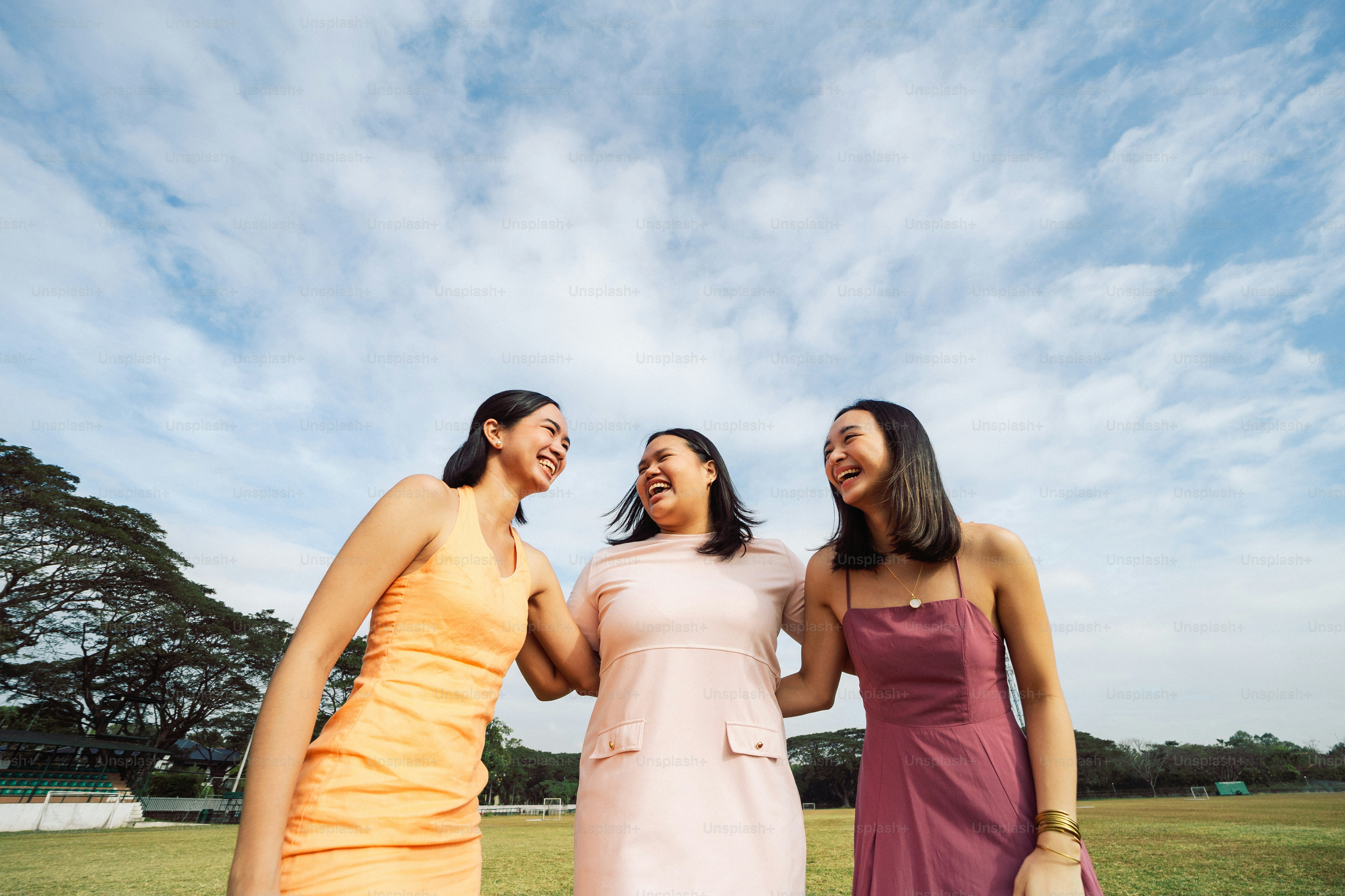 a group of three women standing next to each other
