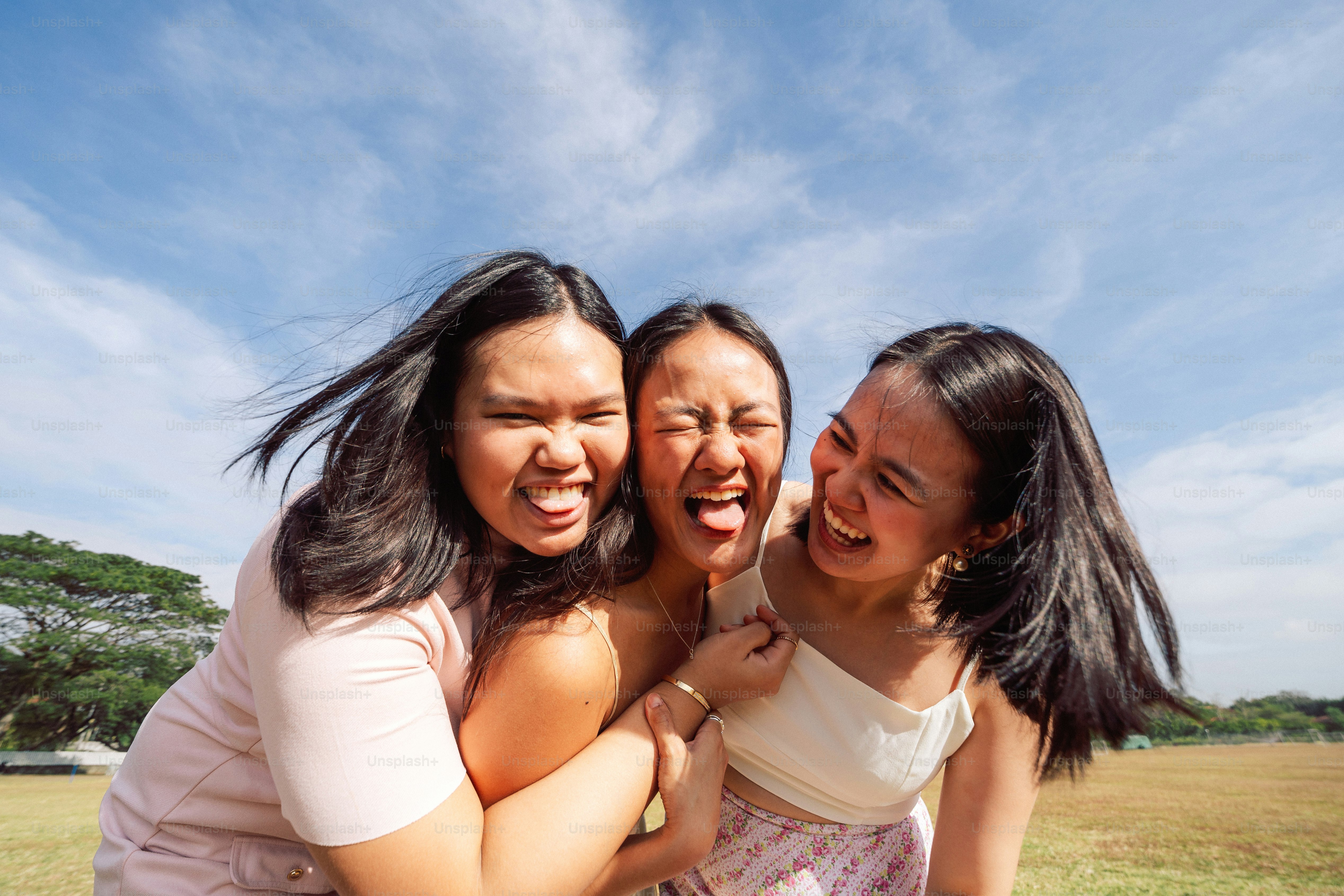 A group of women standing next to each other in a field photo – Woman ...