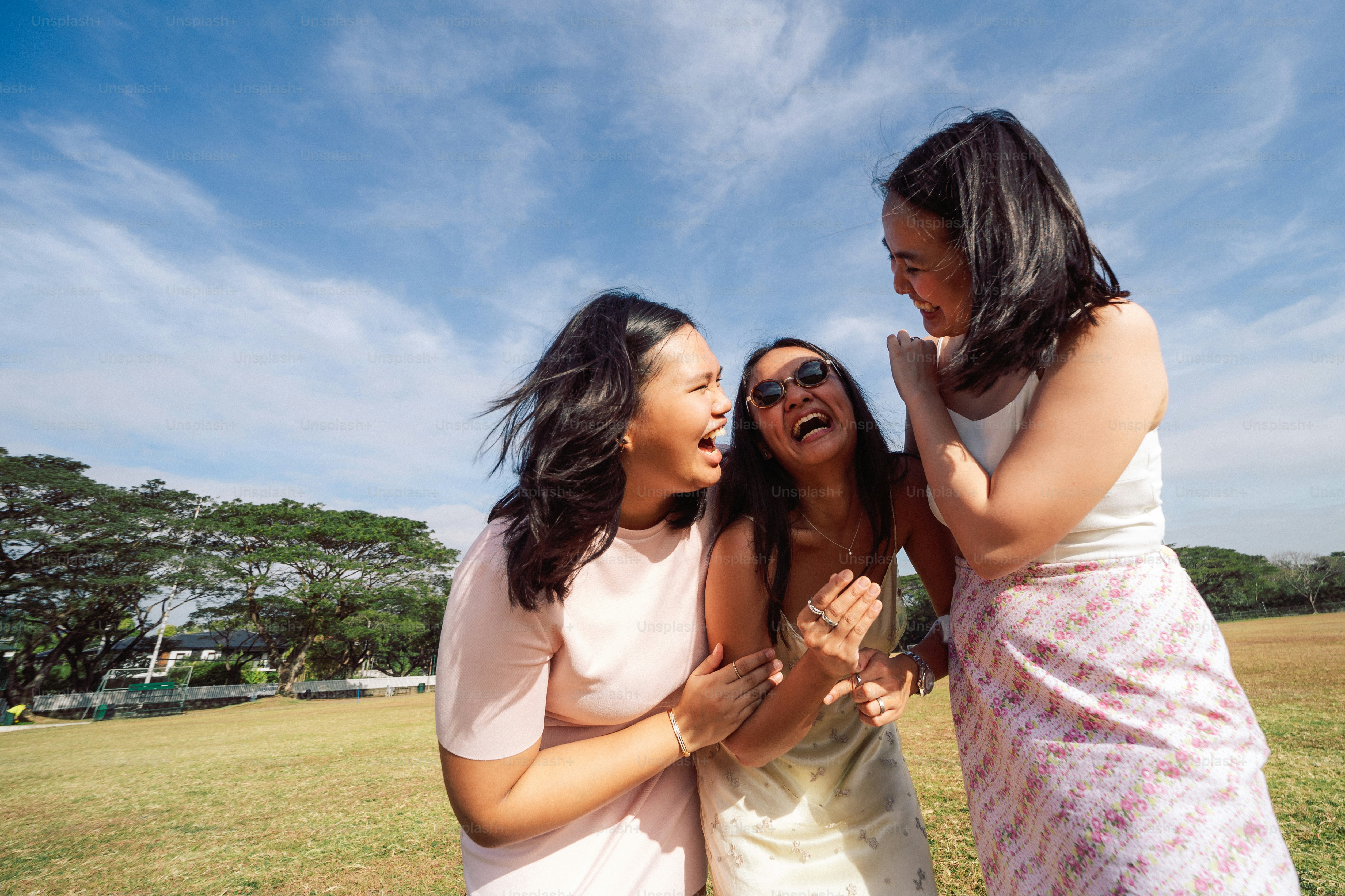 a group of three women standing next to each other