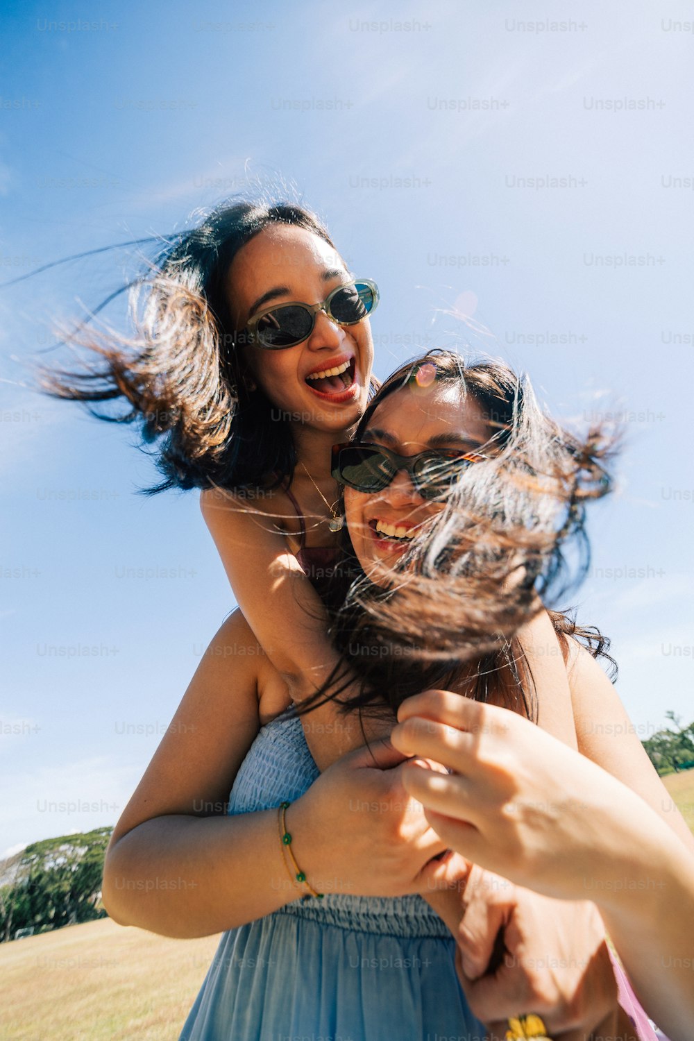 a woman is being hugged by another woman