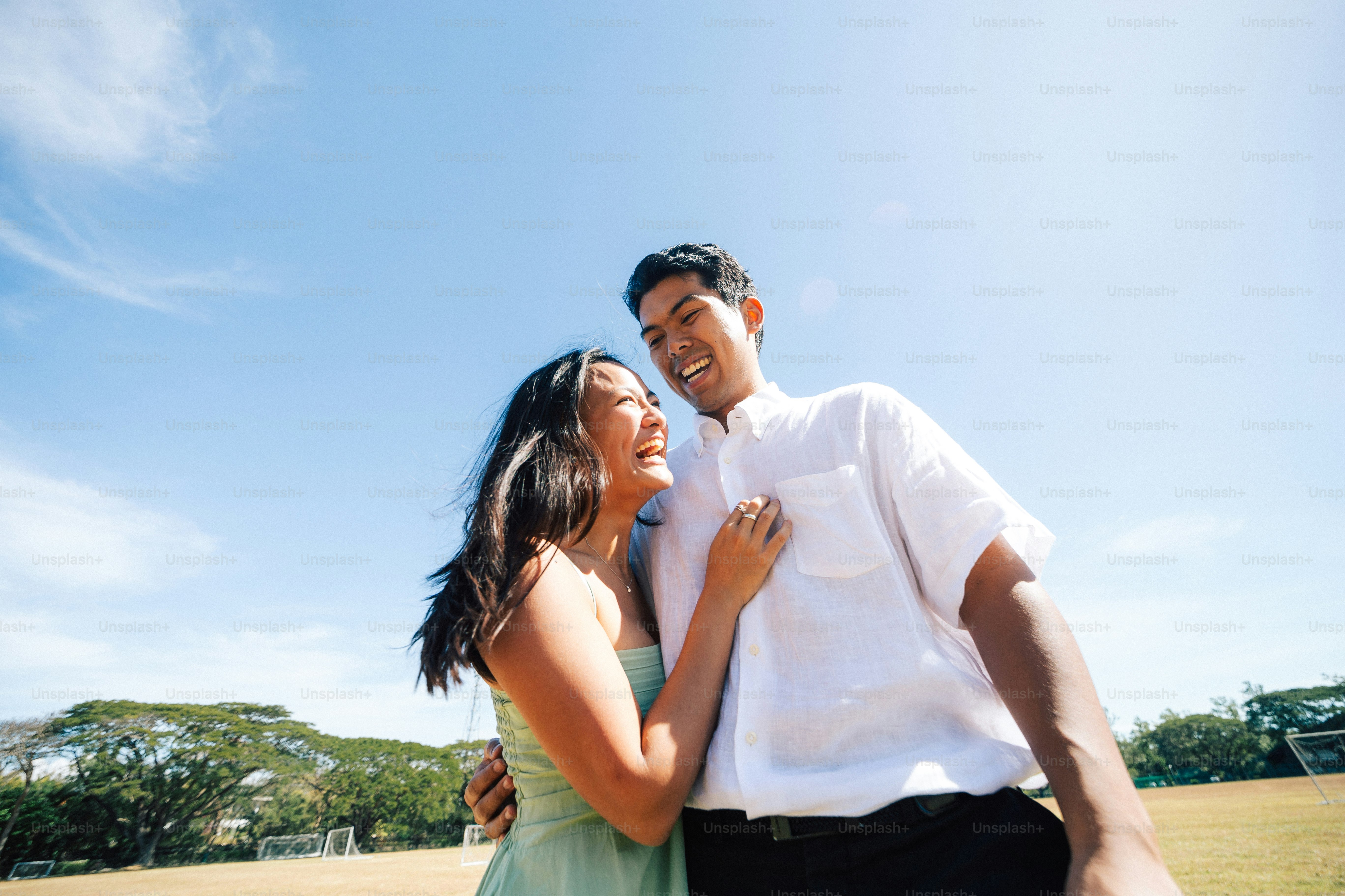 a man and a woman standing together in a field