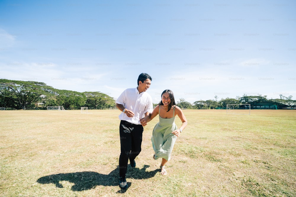 a man and a woman running in a field