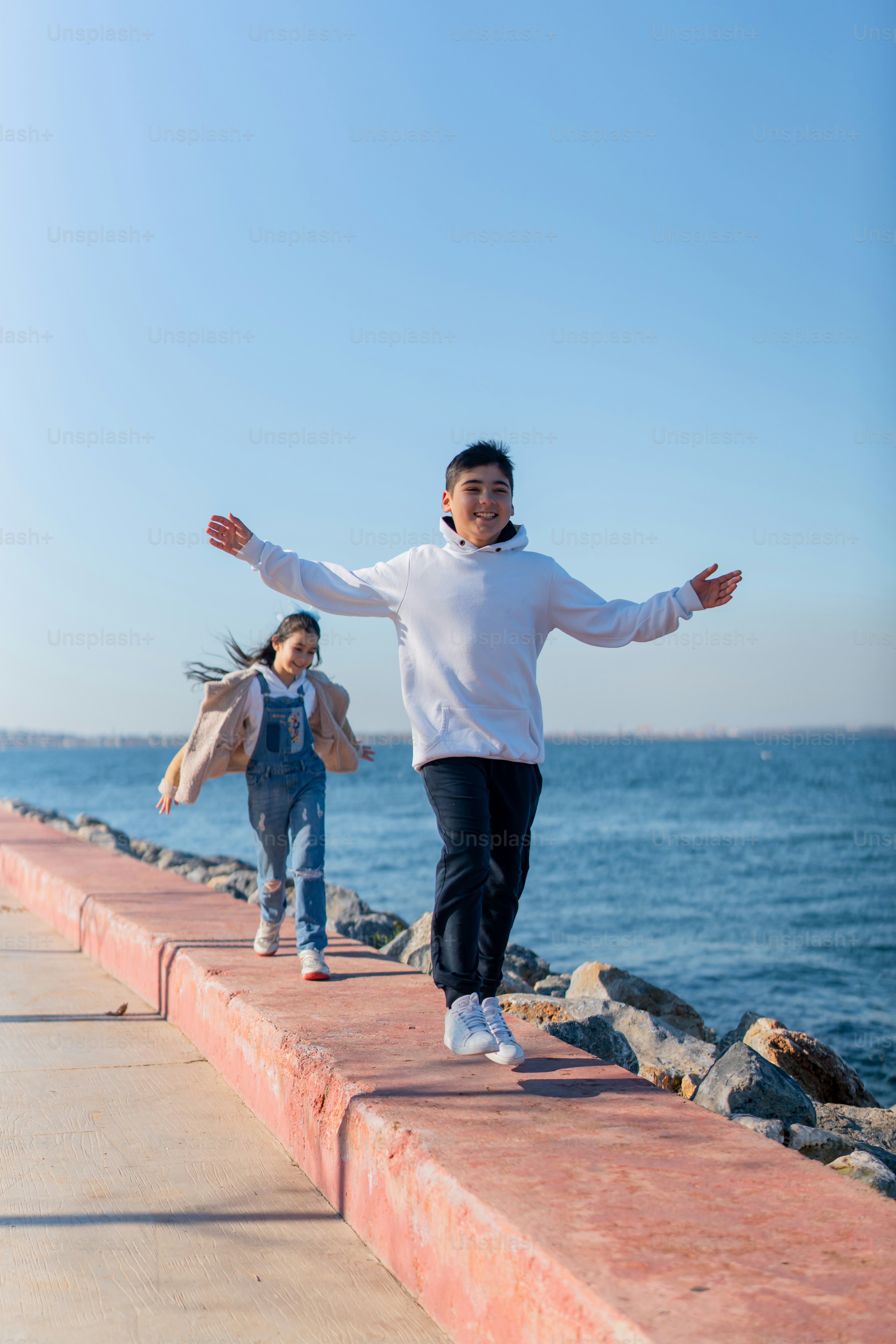 a couple of people that are standing on a pier
