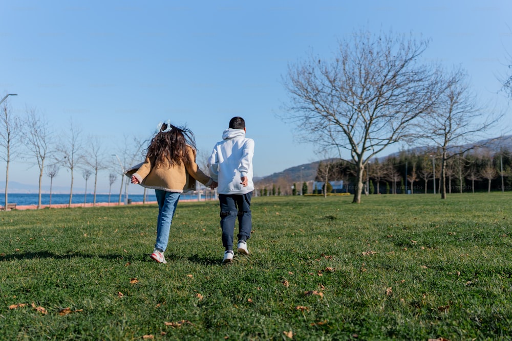 a man and a woman walking through a park