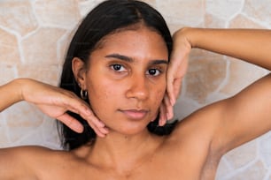 a woman with freckles on her chest posing for a picture