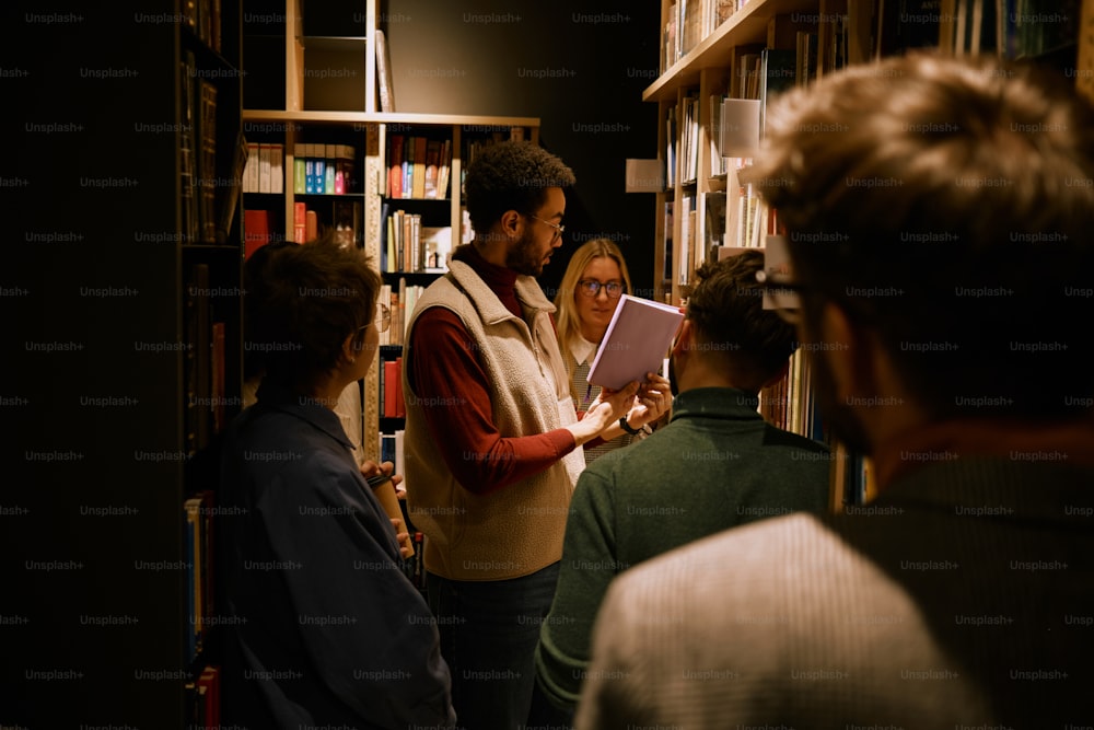 a group of people standing in a library