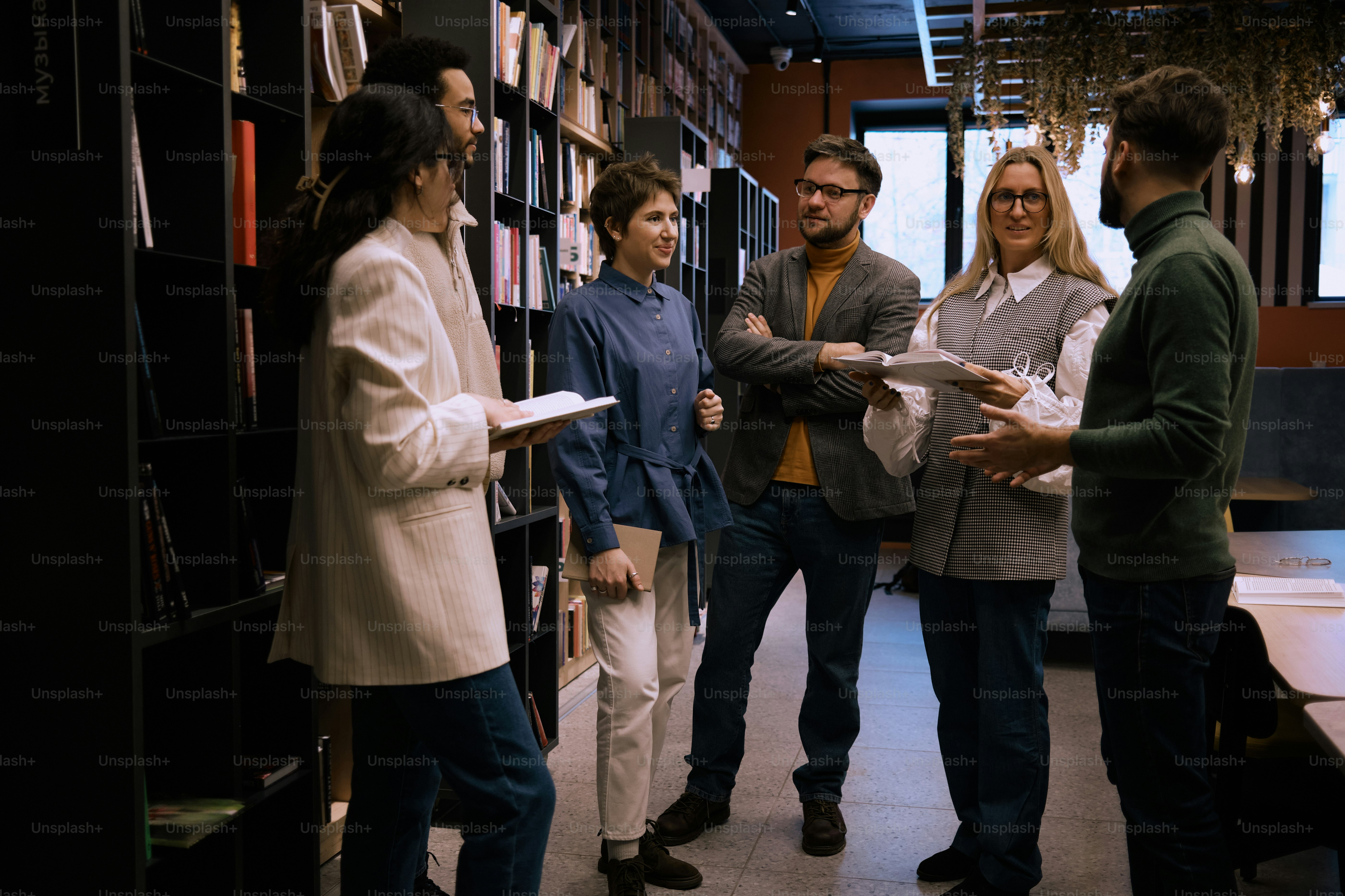 a group of people standing in a library