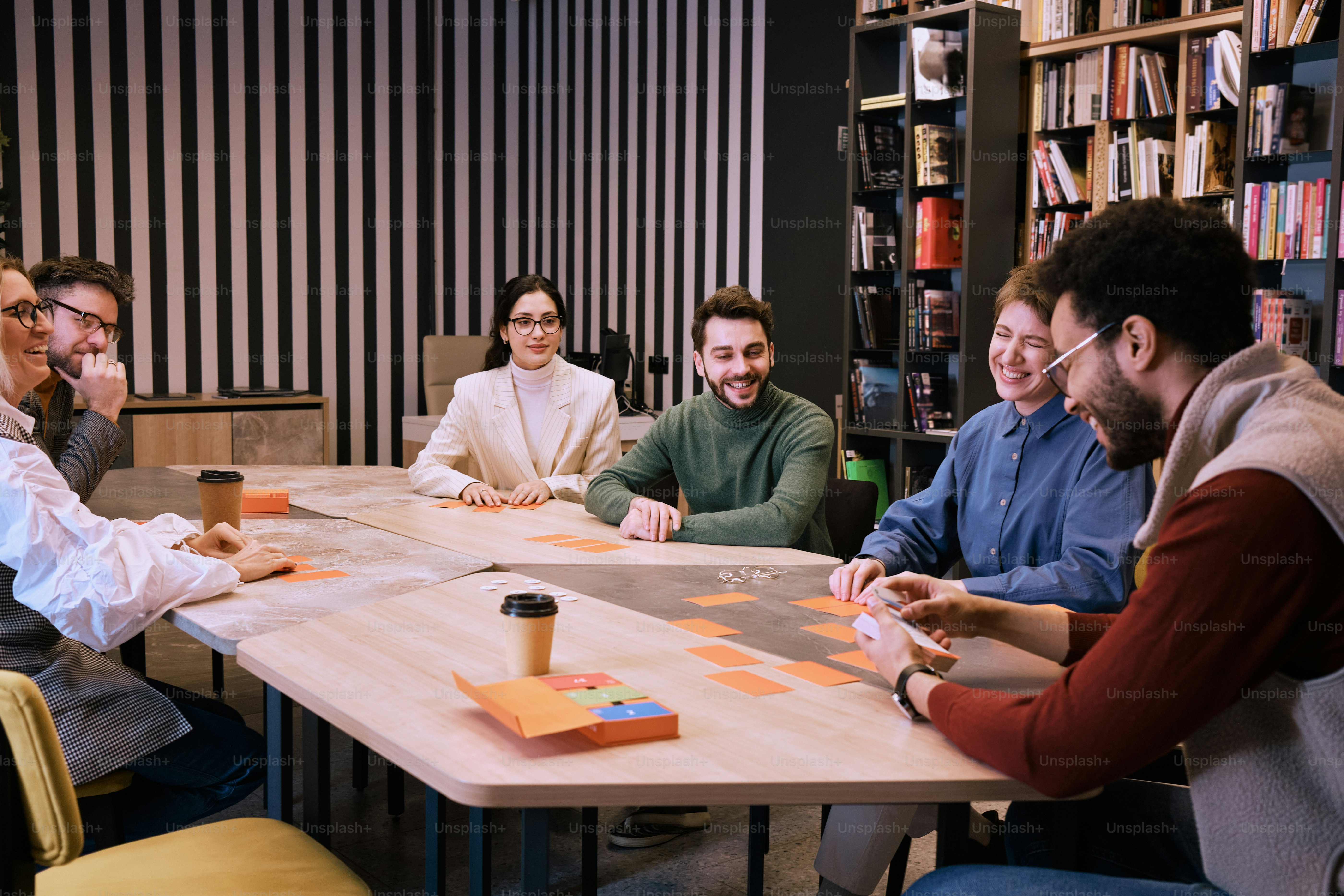 a group of people sitting around a table playing a game