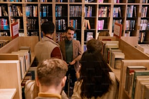 a group of people standing in a library