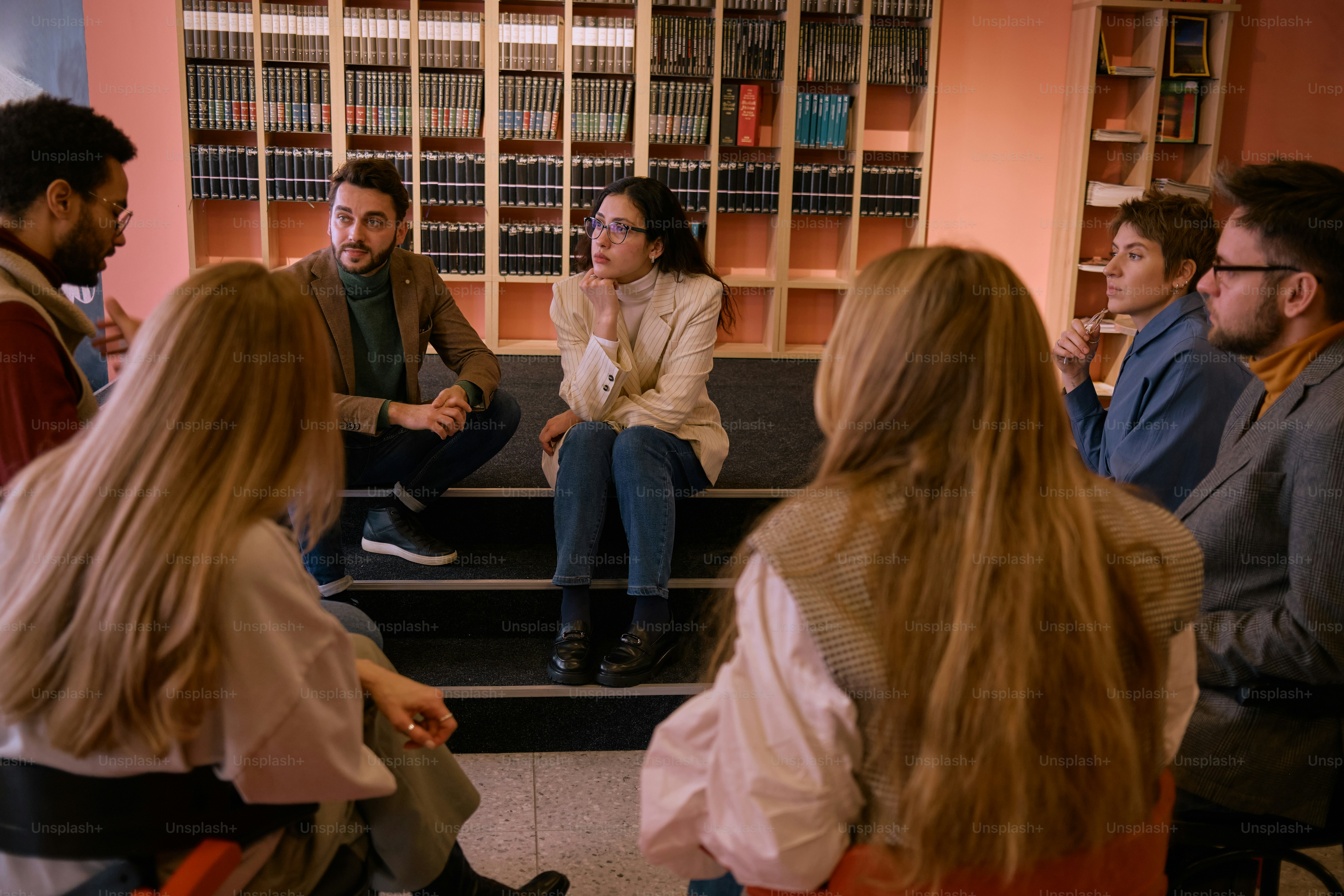 a group of people sitting on a set of stairs