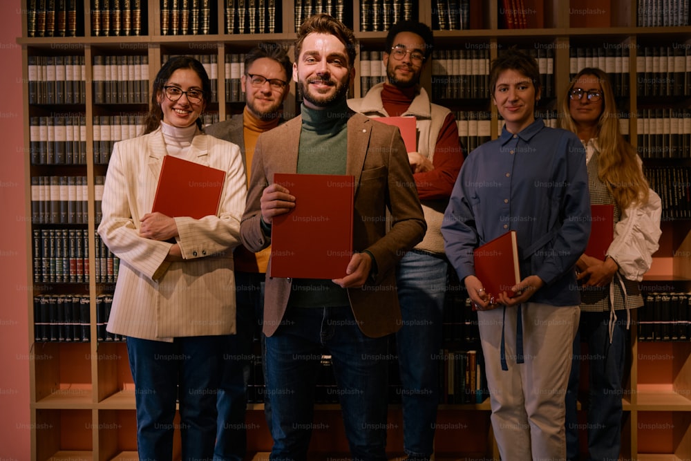 a group of people standing in front of a bookshelf
