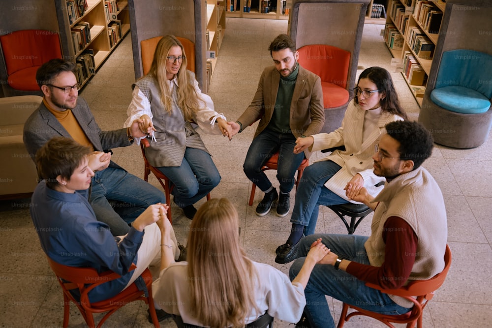 a group of people sitting around each other