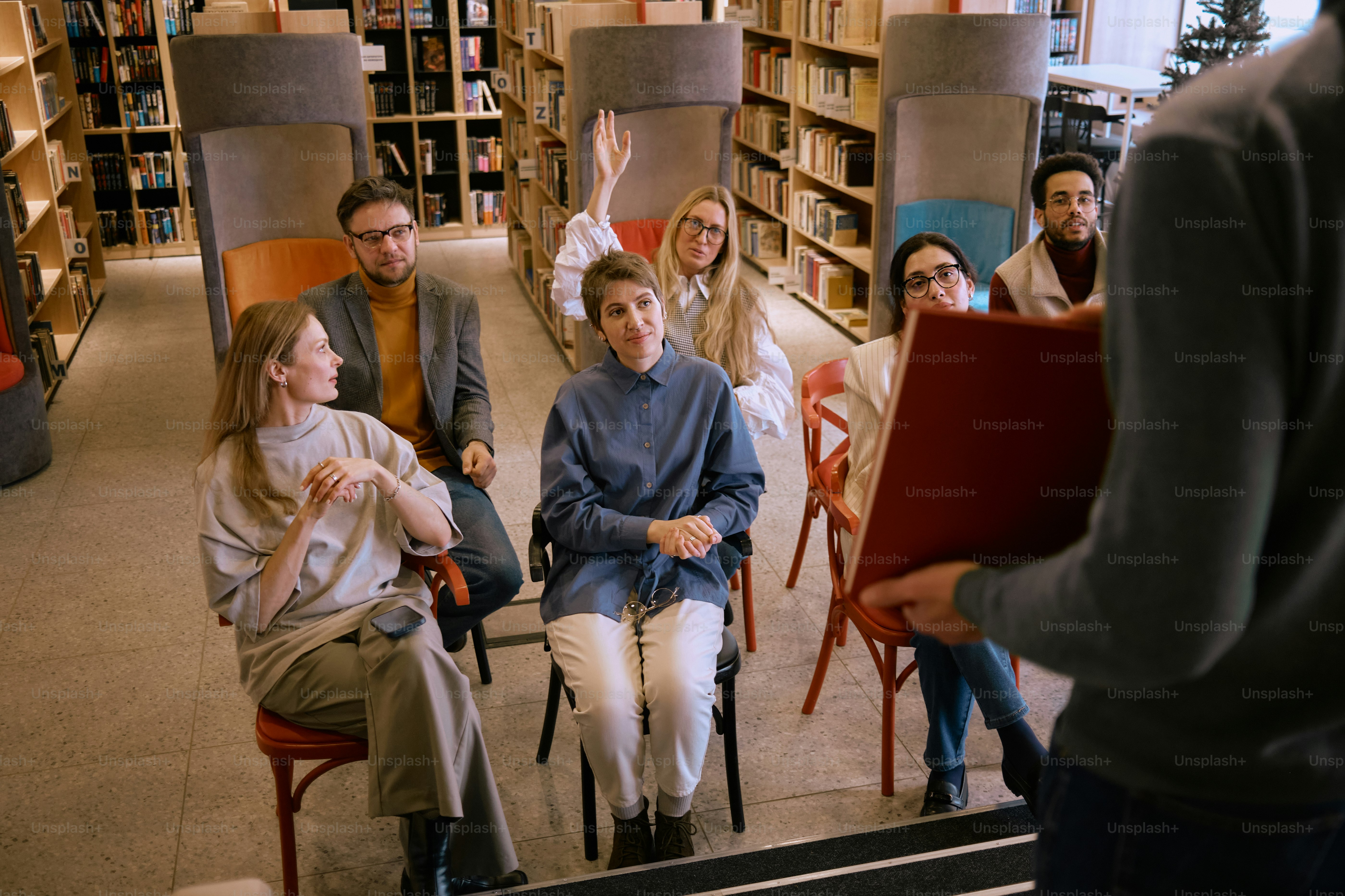 a group of people sitting in chairs in a library