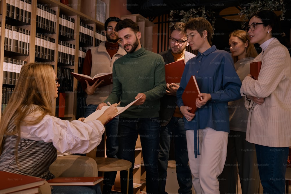 a group of people standing around a library