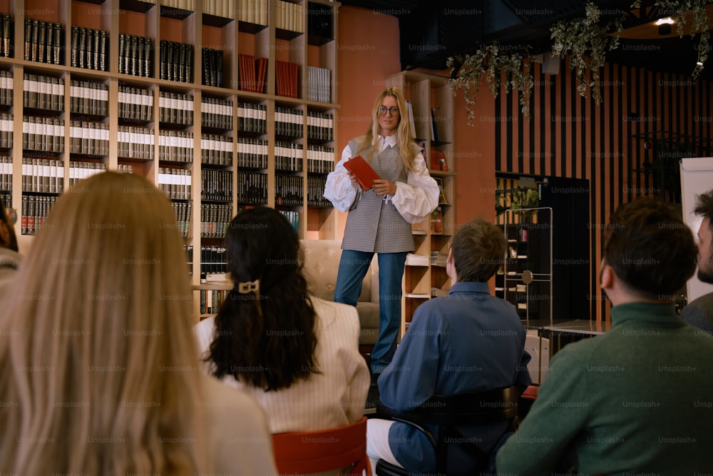 a woman standing in front of a group of people