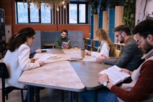 a group of people sitting around a table