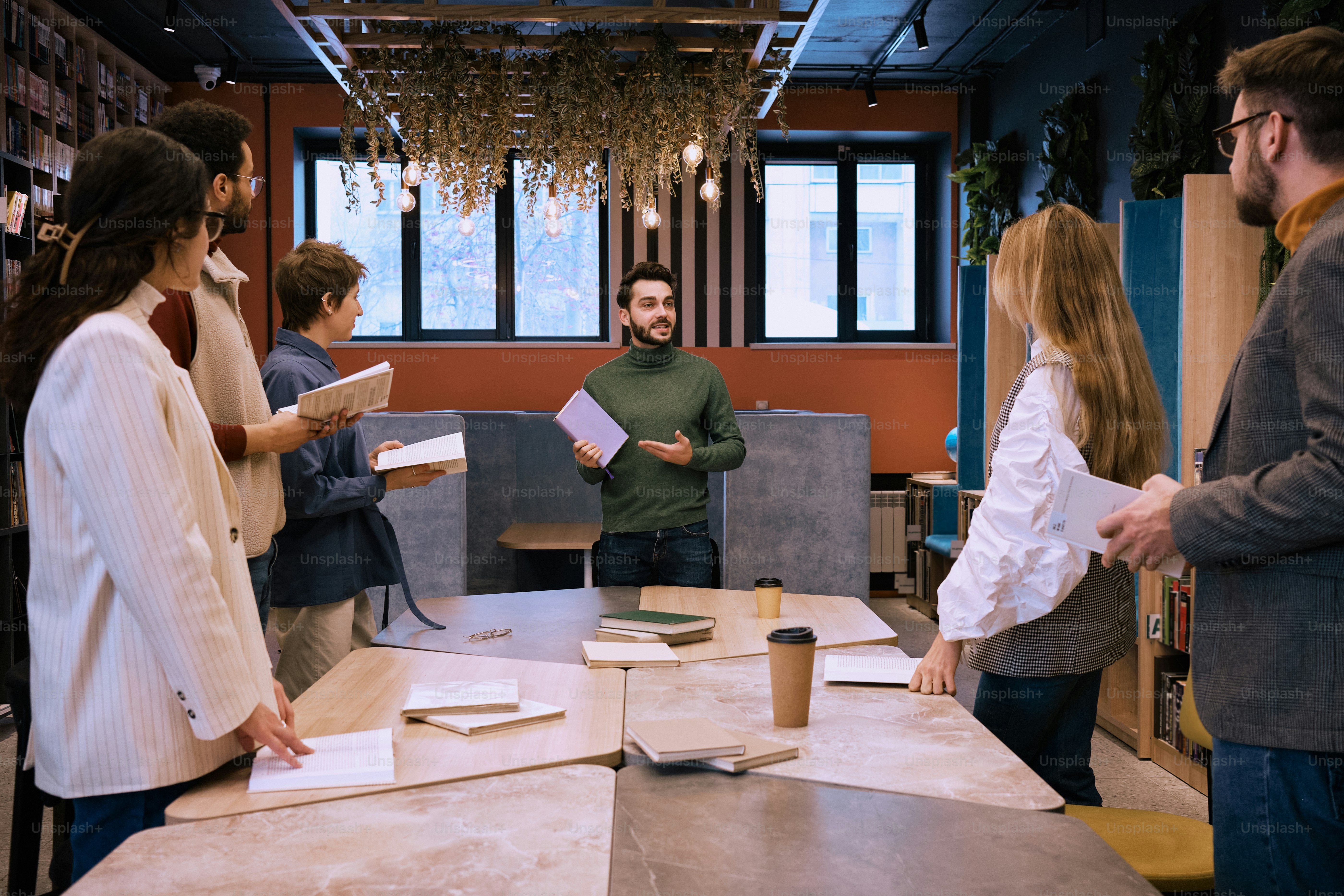 a group of people standing around a table