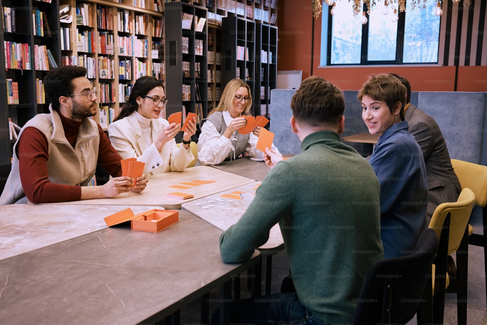 un gruppo di persone sedute intorno a un tavolo in una biblioteca
