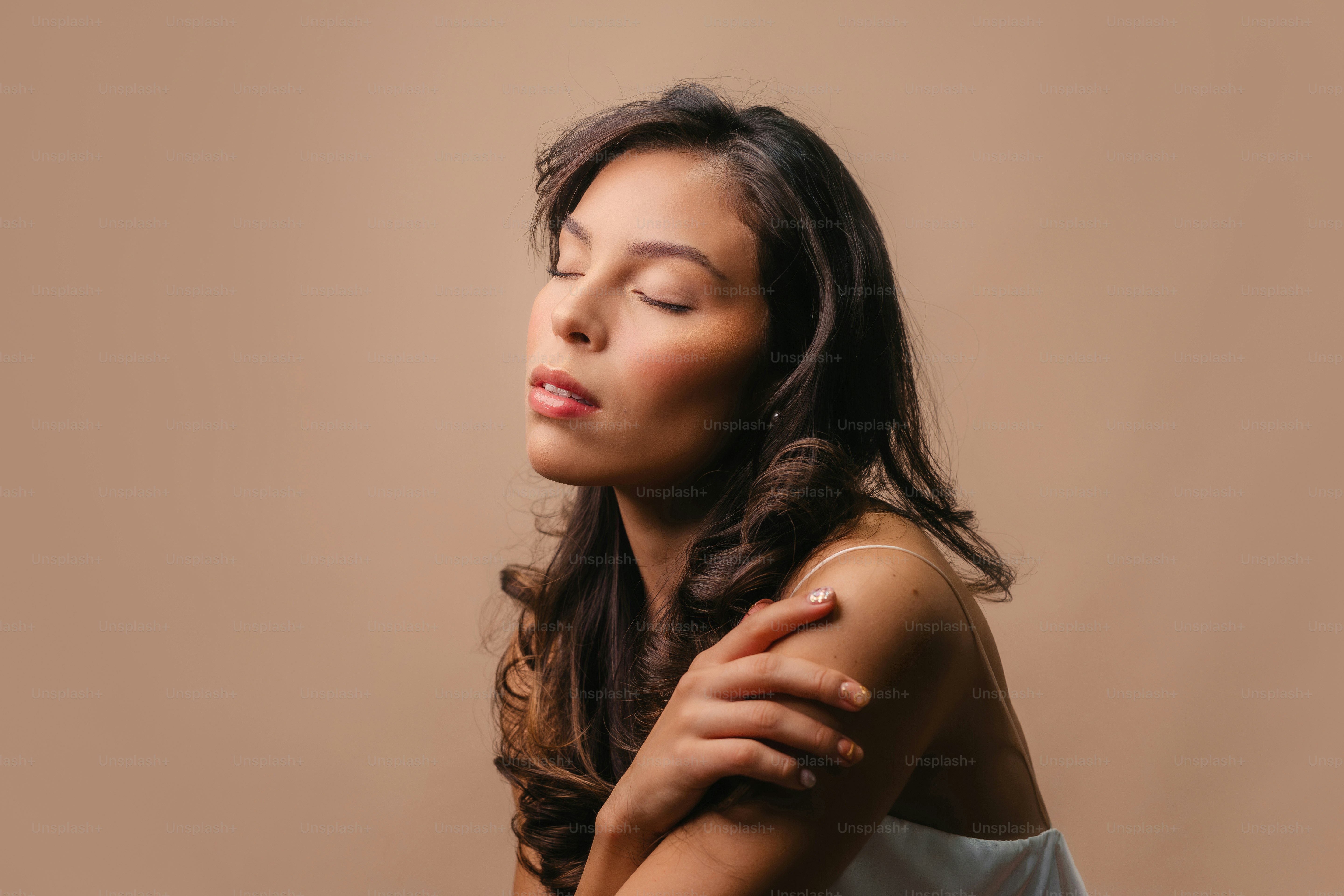 A woman with her eyes closed sitting down photo – Portrait Image on ...
