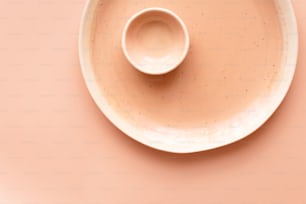 a white plate with a small bowl on top of it