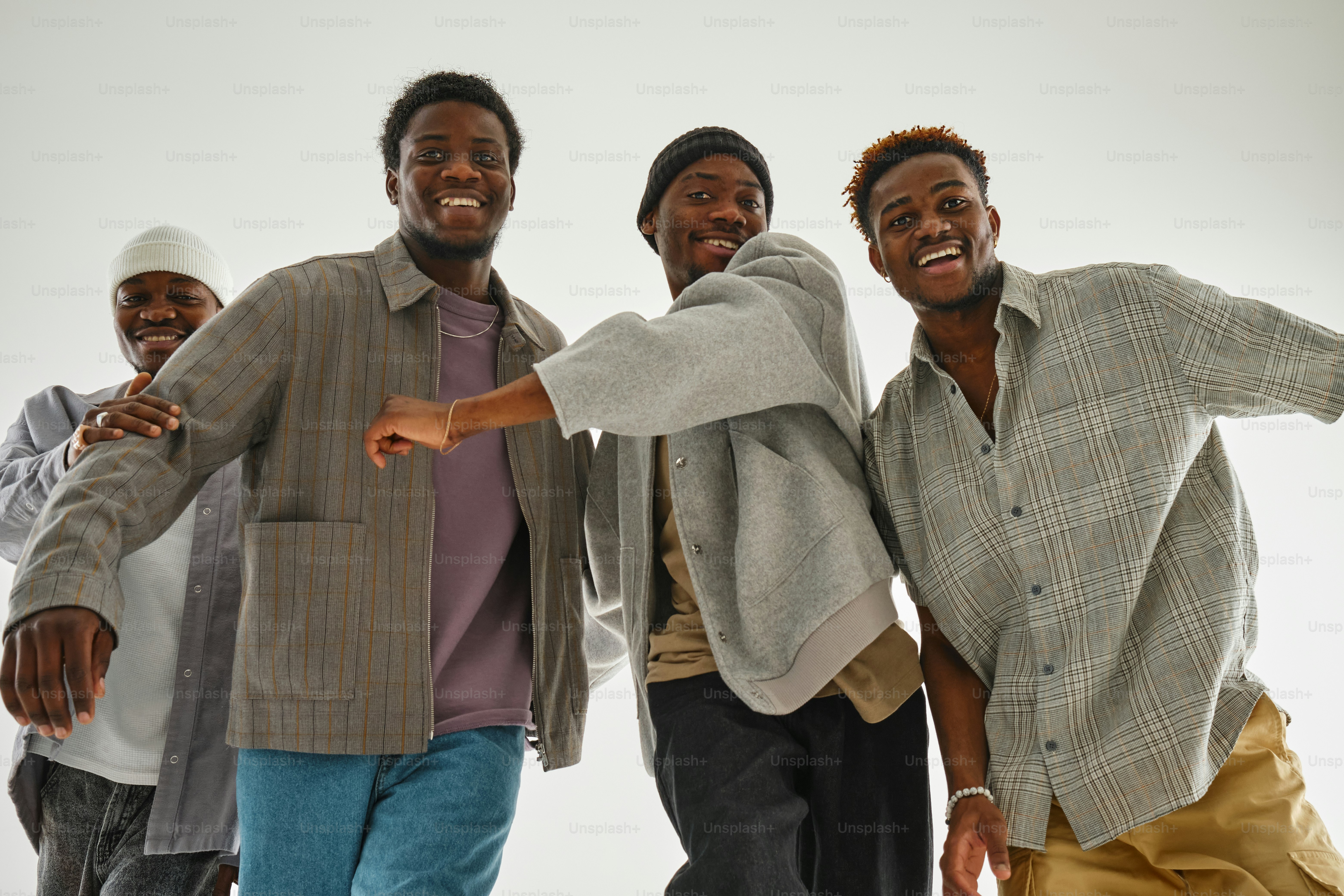 A group of young men standing next to each other photo – Black Image on ...