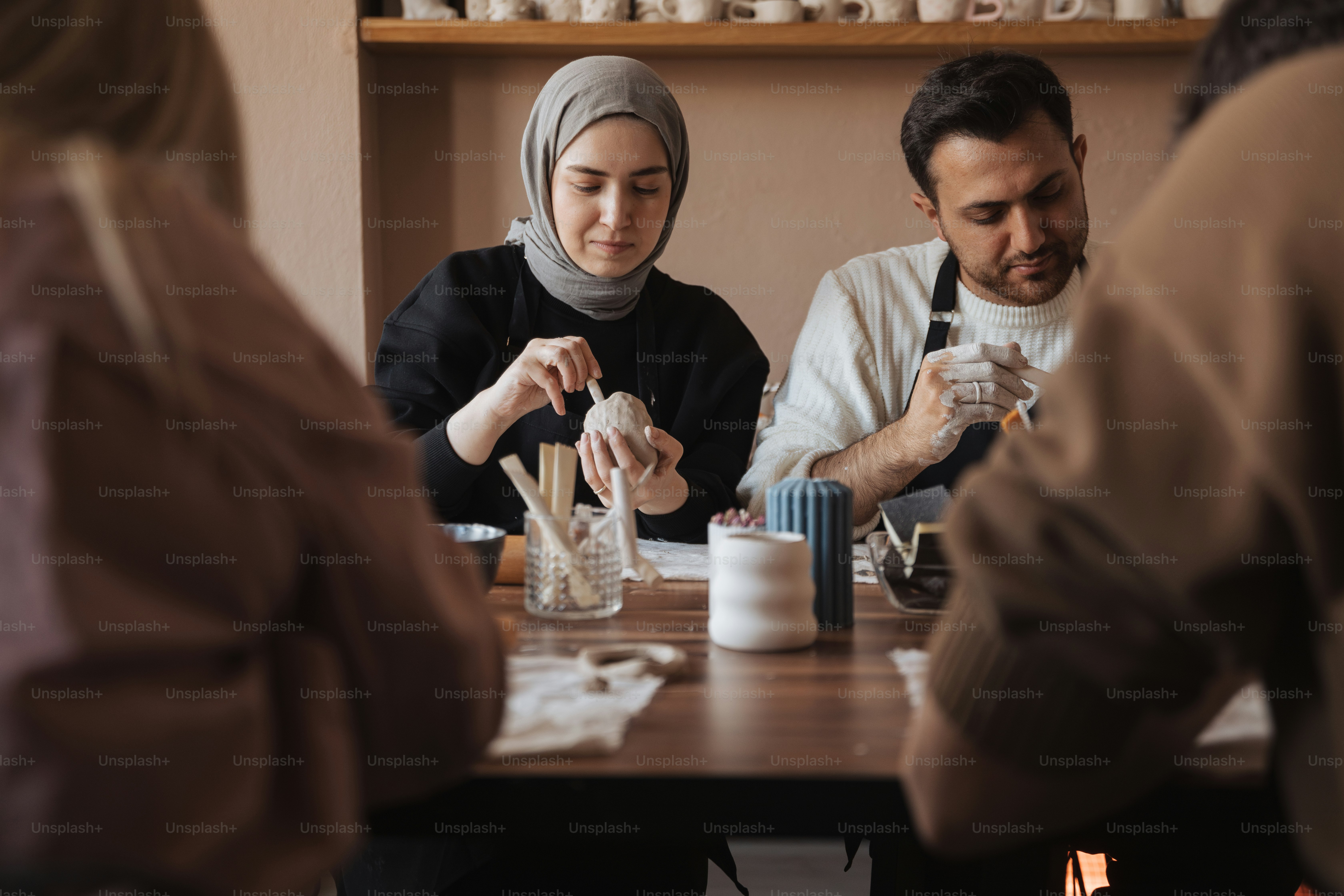 a group of people sitting around a wooden table
