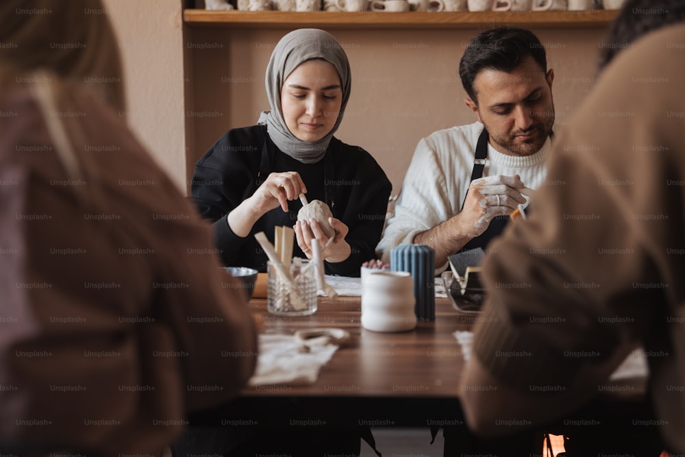 a group of people sitting around a wooden table