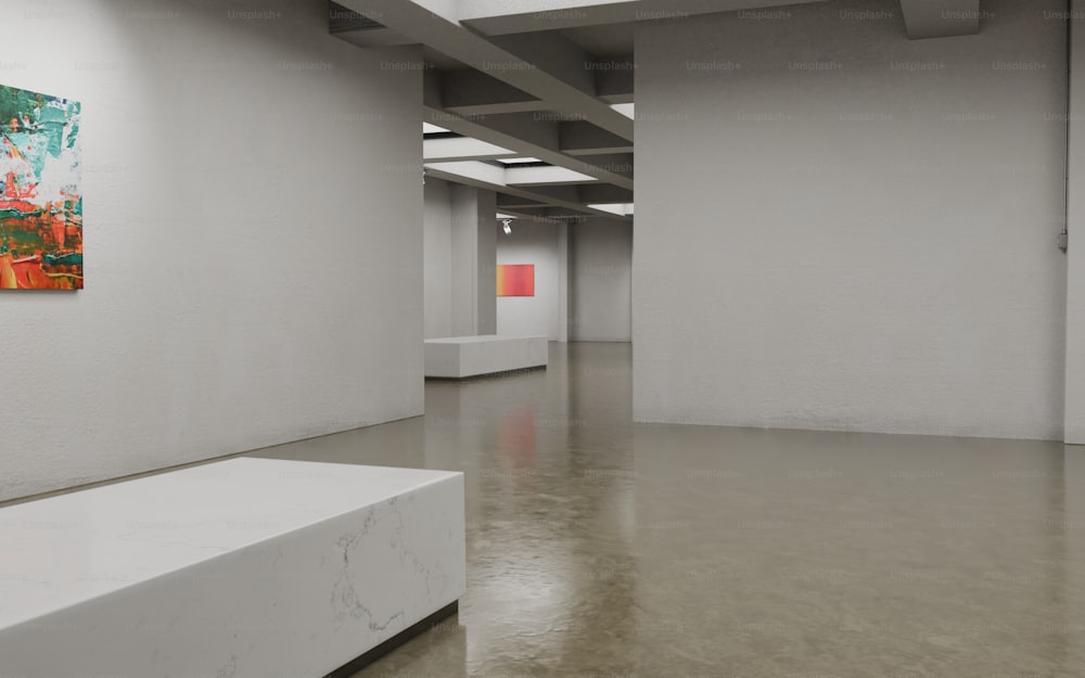 an empty room with white walls and a painting on the wall