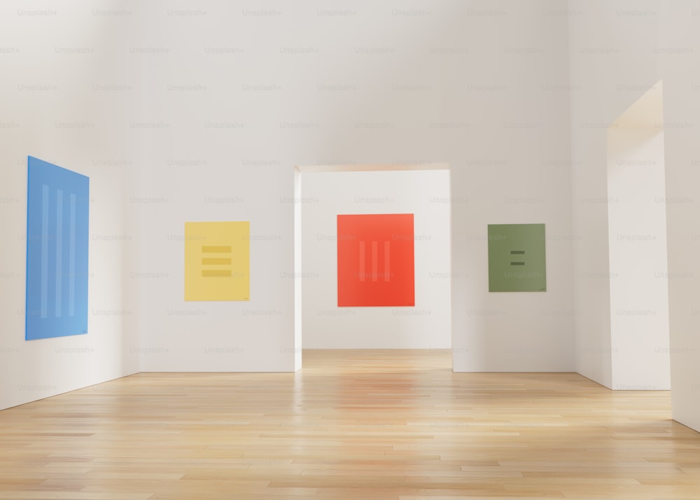 an empty room with three different colored paintings on the wall