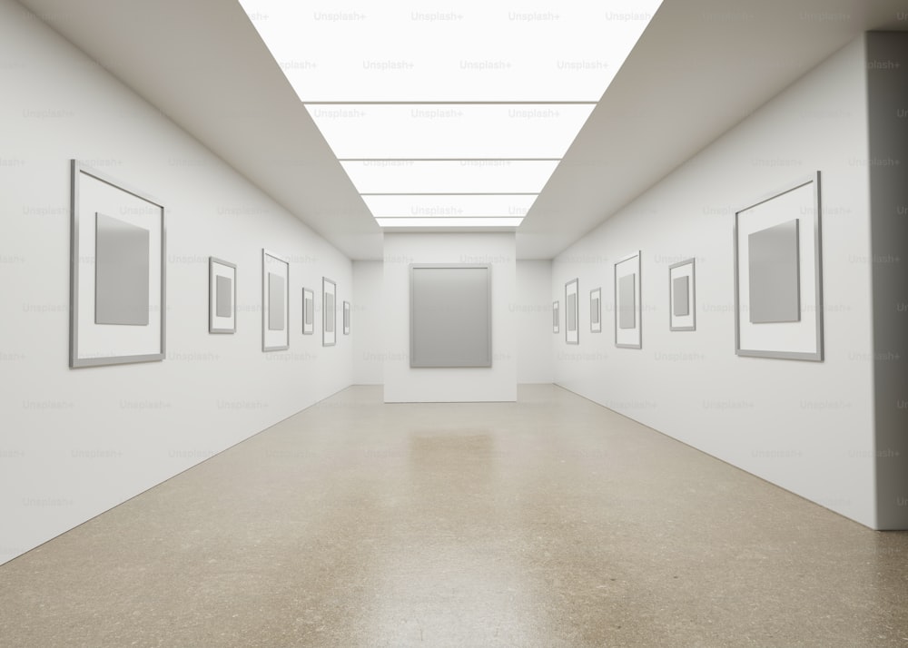 an empty white room with pictures on the wall