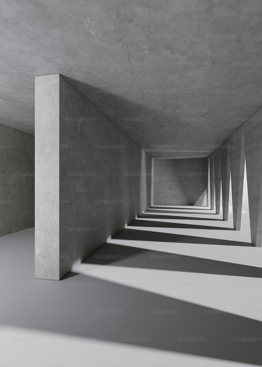 a long row of concrete pillars in a room