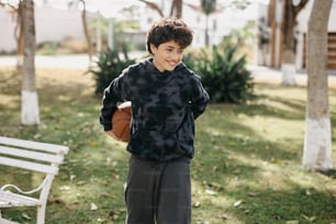 um jovem segurando uma bola de basquete ao lado de um banco