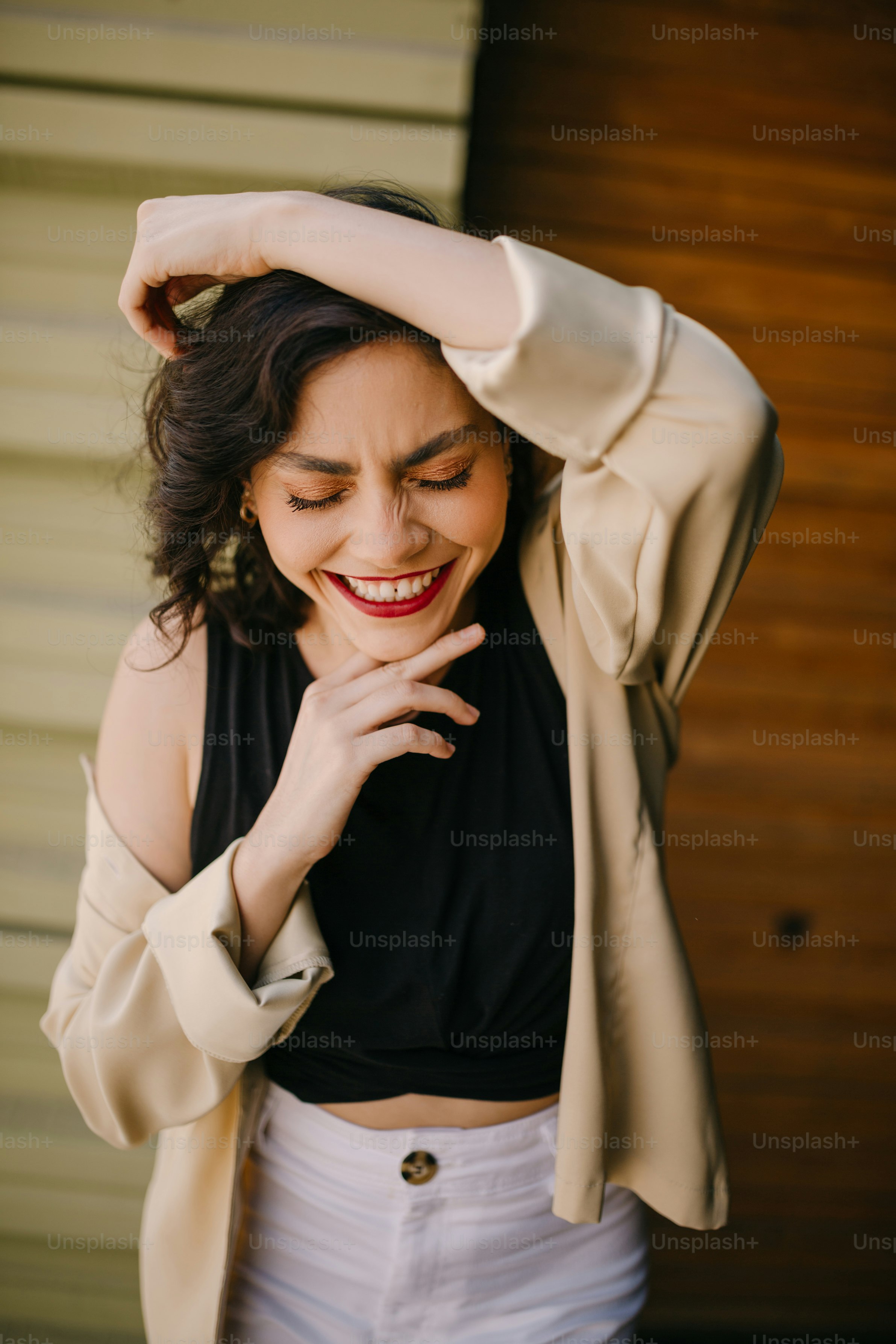 a woman in a black top and white skirt