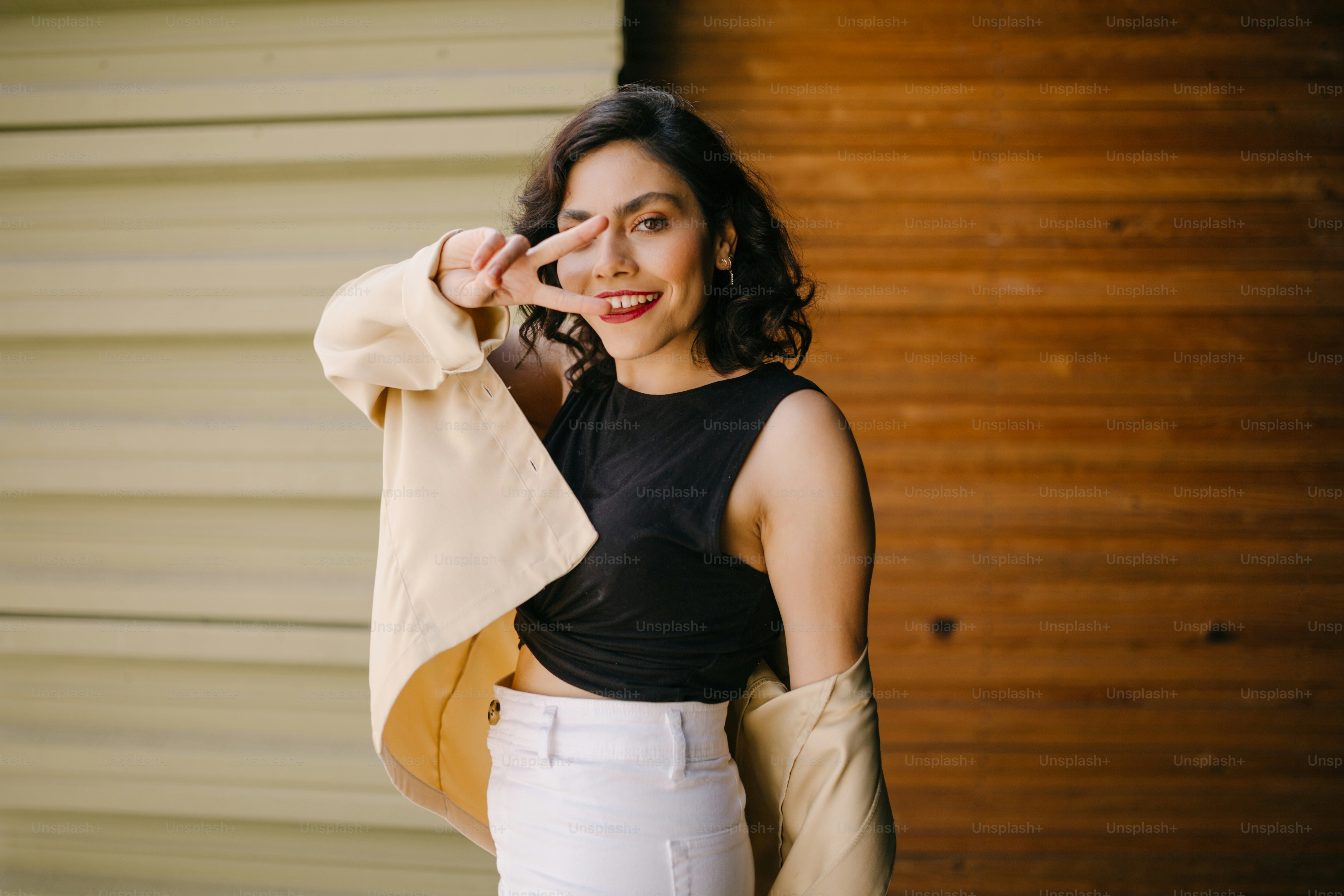 a woman in a black top and white pants