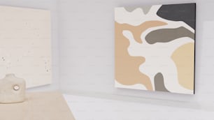 two paintings hang on a wall next to a wooden sculpture