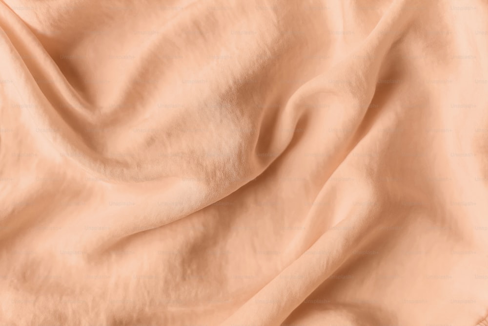 a close up view of a peach colored fabric