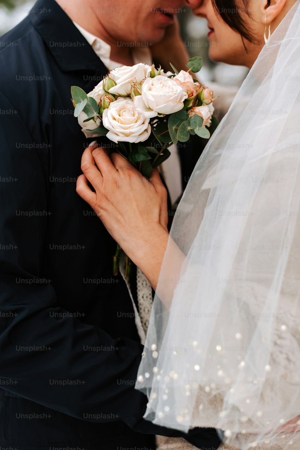 a bride and groom embracing each other