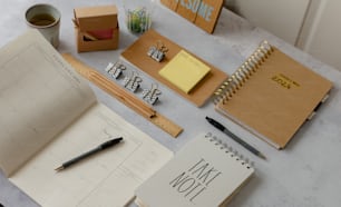 a table topped with notebooks and a cup of coffee