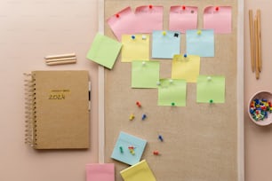 a bulletin board covered in post it notes