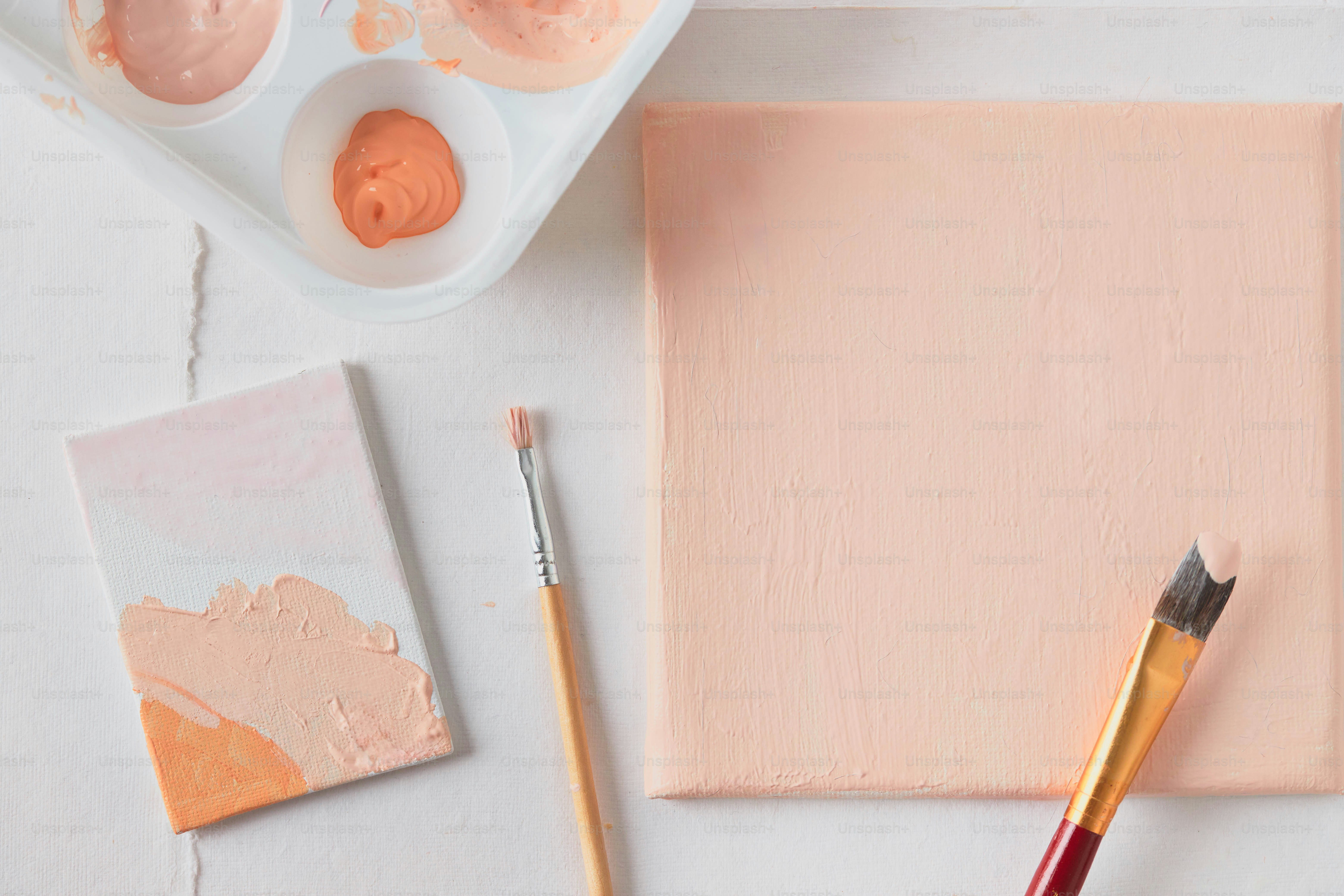 a table with paint, a brush, and a palette