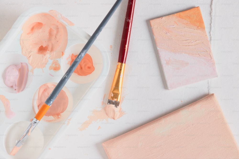 a palette of paint and a paintbrush on a table