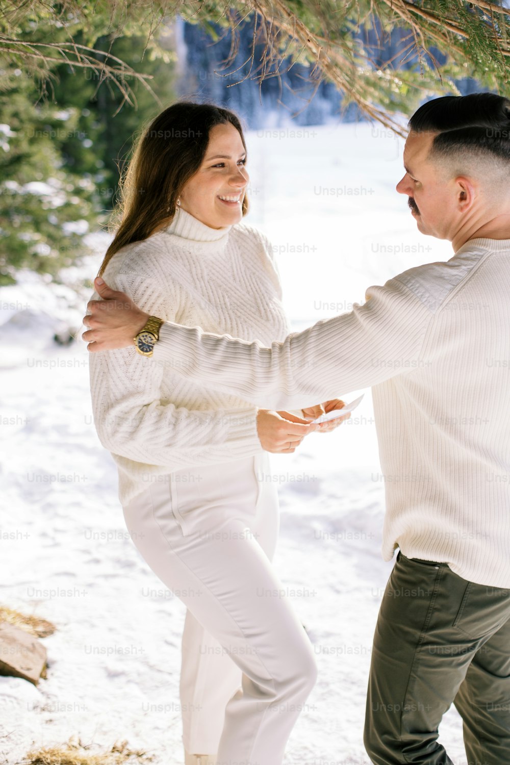 a man and a woman dancing in the snow