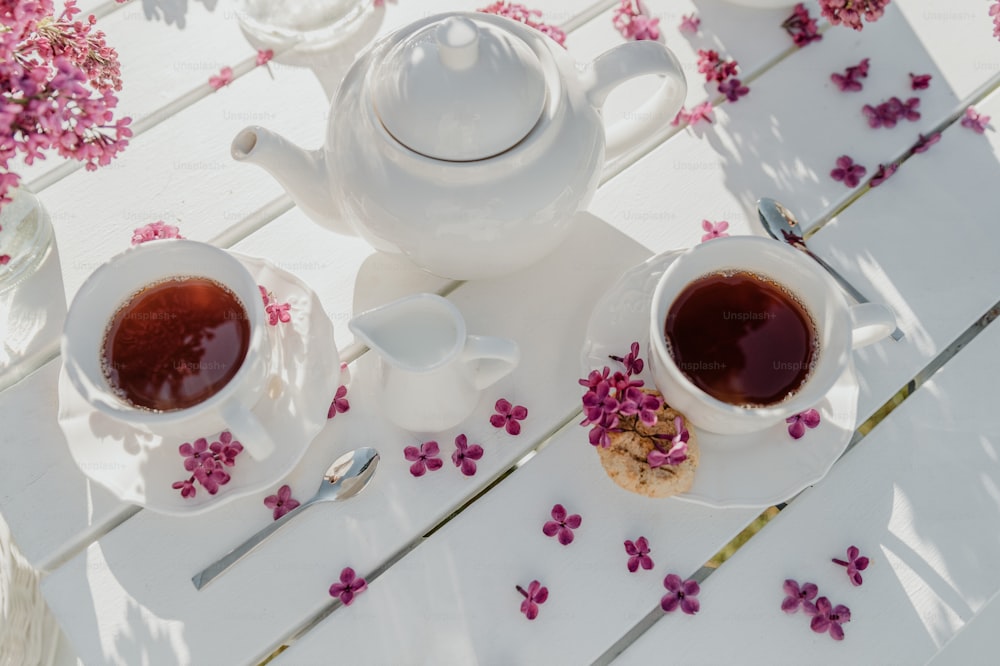a couple of cups of tea sitting on top of a white table