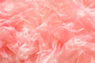 a pile of pink plastic bags sitting on top of a table