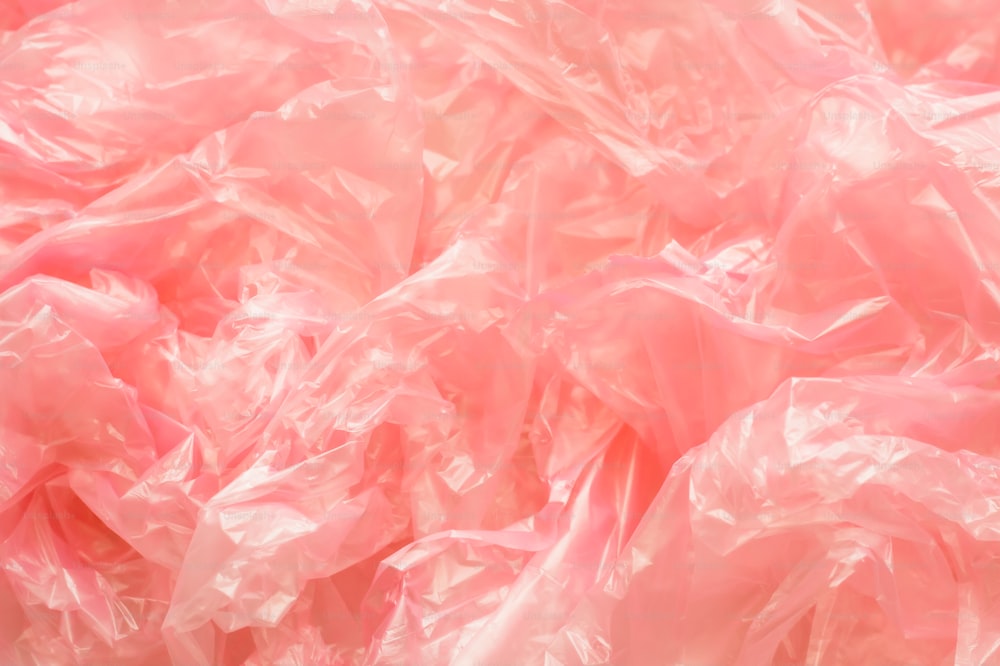 a pile of pink plastic bags sitting on top of a table