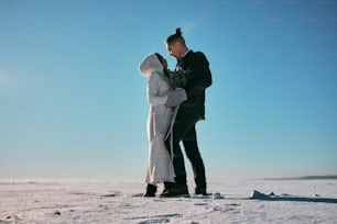 a man and a woman standing in the snow