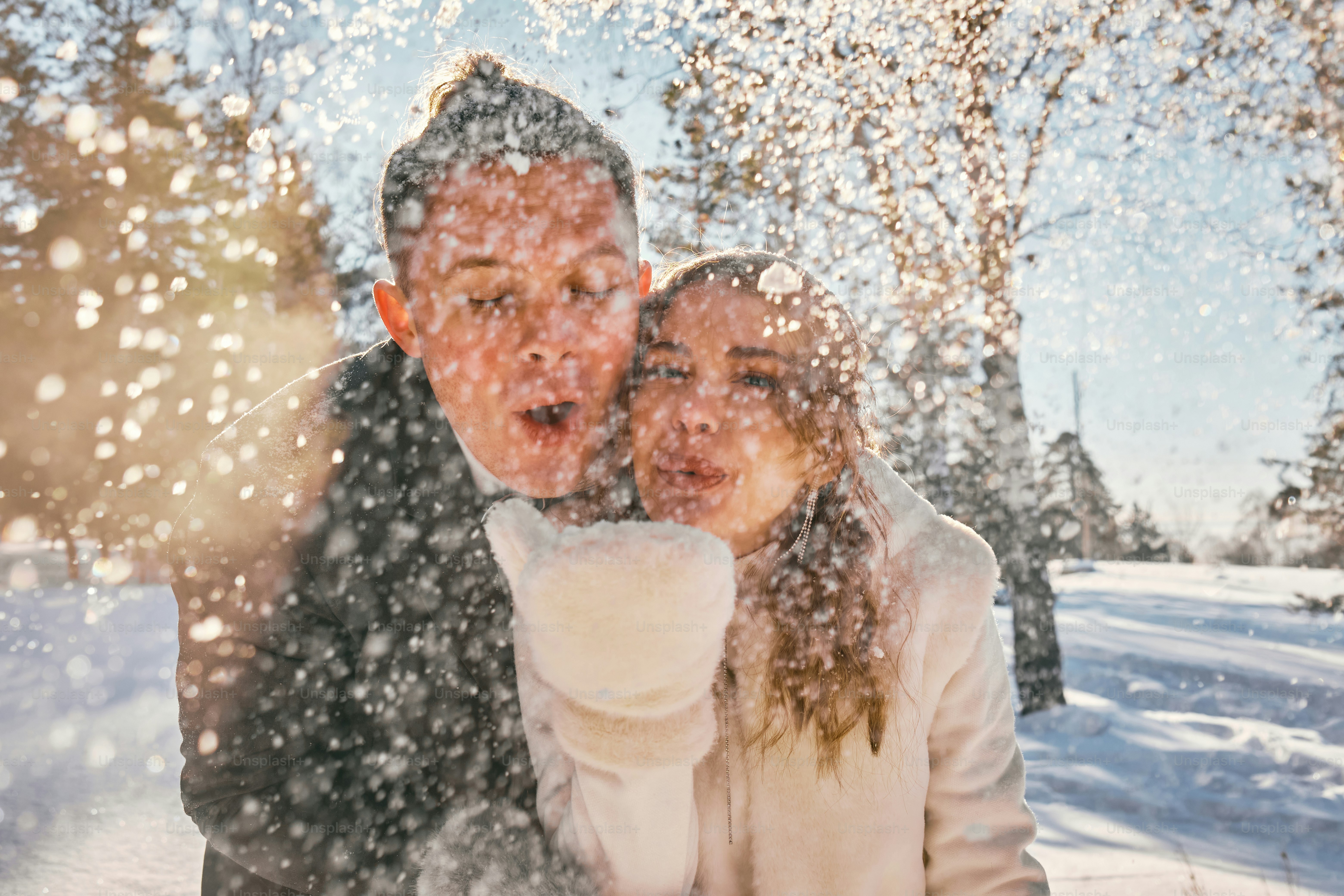 a man and a woman standing in the snow