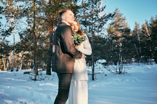 a man and a woman standing in the snow